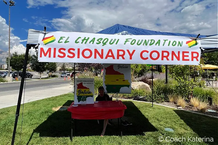 Photo of the booth at the Annual Bolivian Festival with a banner that says El Chasqui Foundation Missionary Corner
