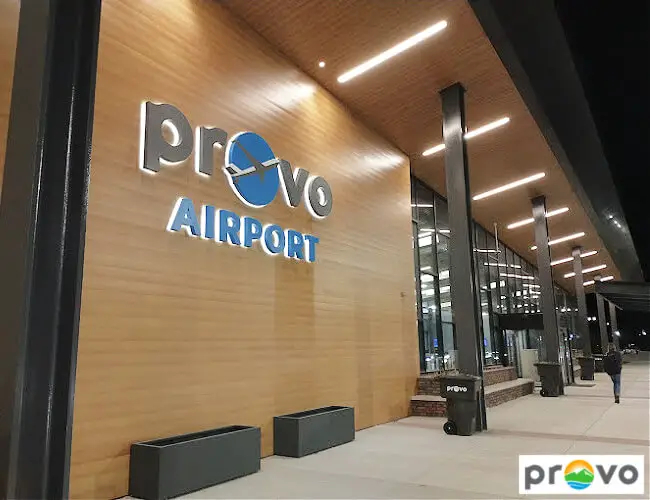 A photo of the Provo Airport taken during night time showing the hallway lights and the beautiful architecture of the airport