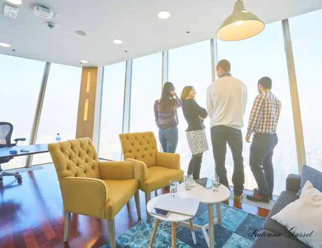 Image showing a small group of employees for a start up company overlooking the view from their office space. Image by Katerina Gasset, Realtor and Owner of the Move to Provo website