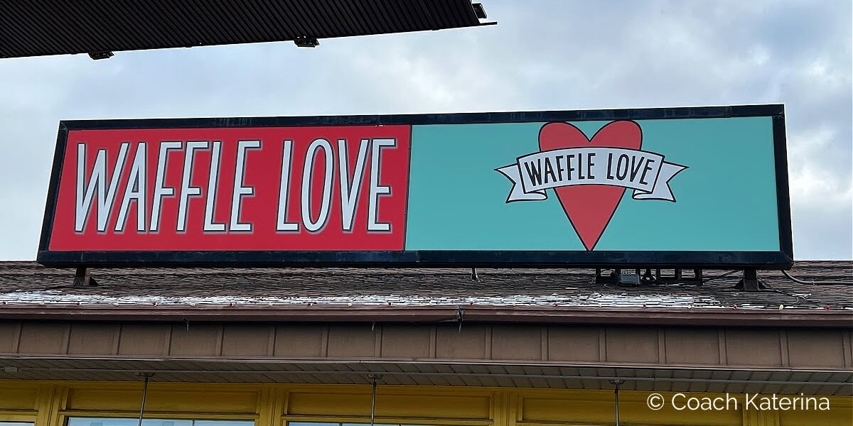 This is a photo of the sign board at Waffle Love at the Shops at Riverwoods. Image by Katerina Gasset, licensed Realtor and restaurant reviewer in Provo Utah...