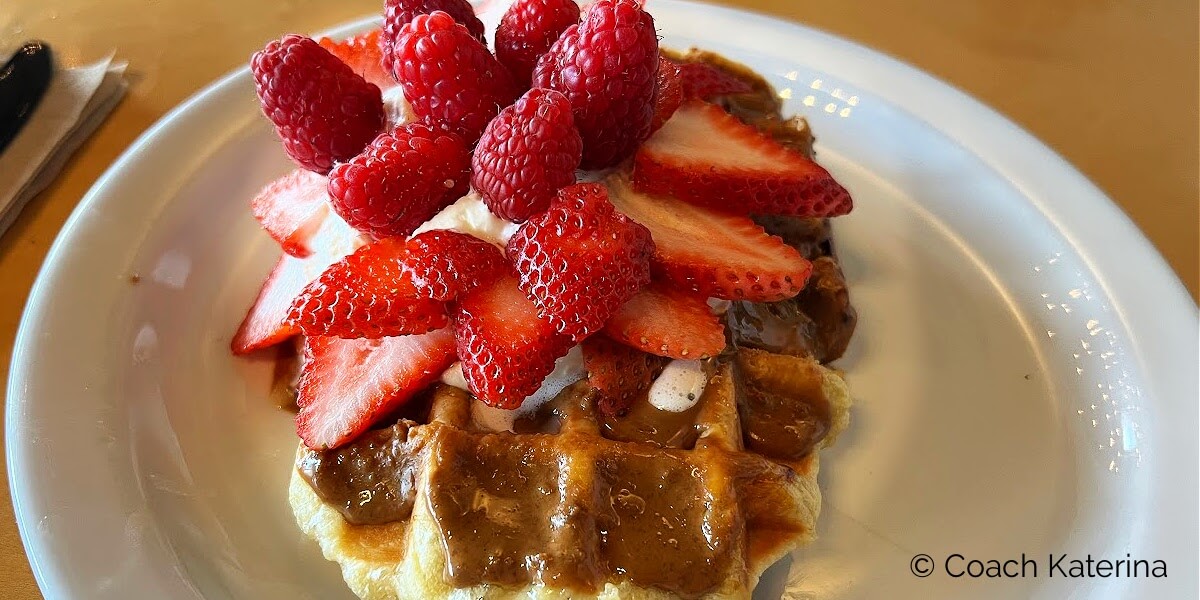 Waffle topped with lots of strawberries served at Waffle Love in State Street Provo Utah...