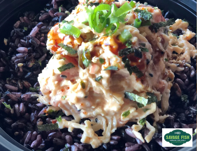 Black rice topped with fresh tuna and authentic herbs and spices served at Savage Fish Hawaiian Poke Restaurant in Orem Utah located at the border of Orem and Provo...