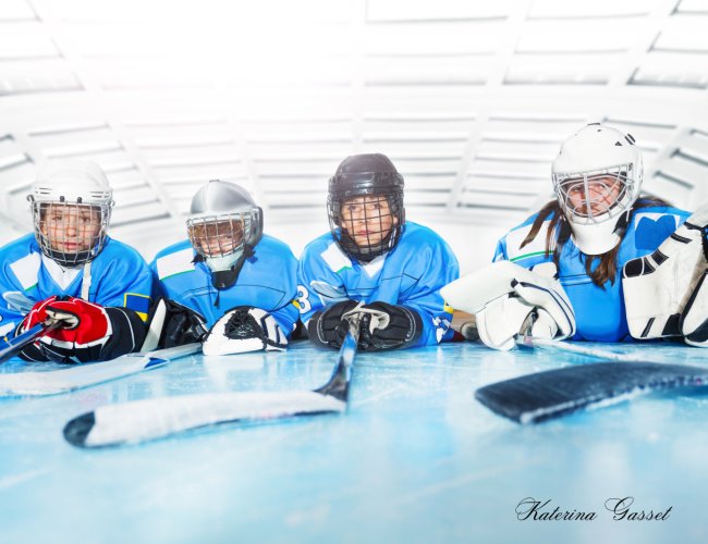 Provo Predators hockey team facing off against the Rock Springs Grizzlies in Provo, Utah, featuring intense on-ice action, players in team jerseys, and an enthusiastic crowd.