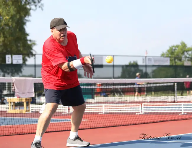 Competitors in action at America's Pickleball Classic, with players of all ages showcasing skillful gameplay on outdoor courts under sunny skies.